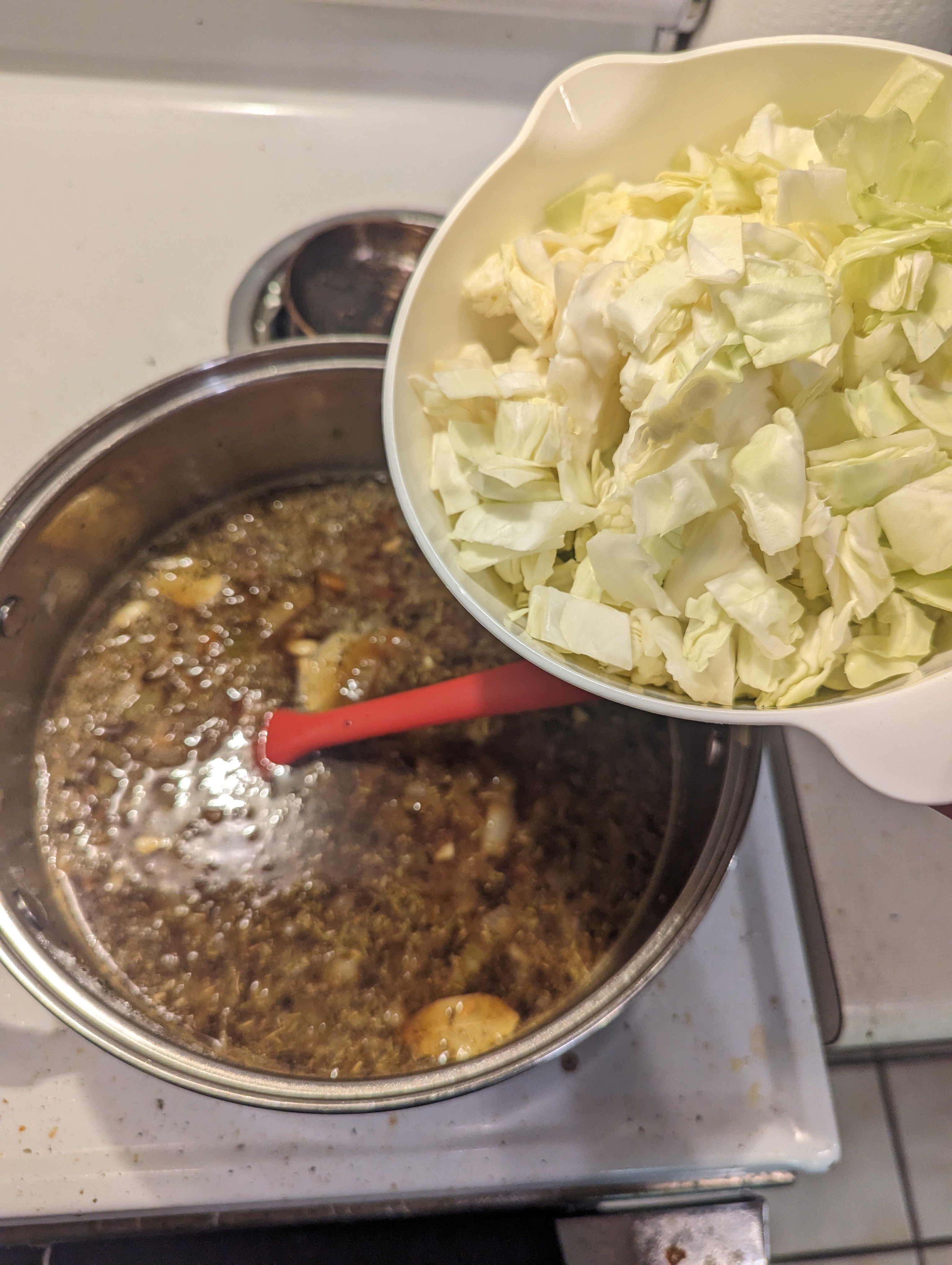 Adding the cabbage to the stew