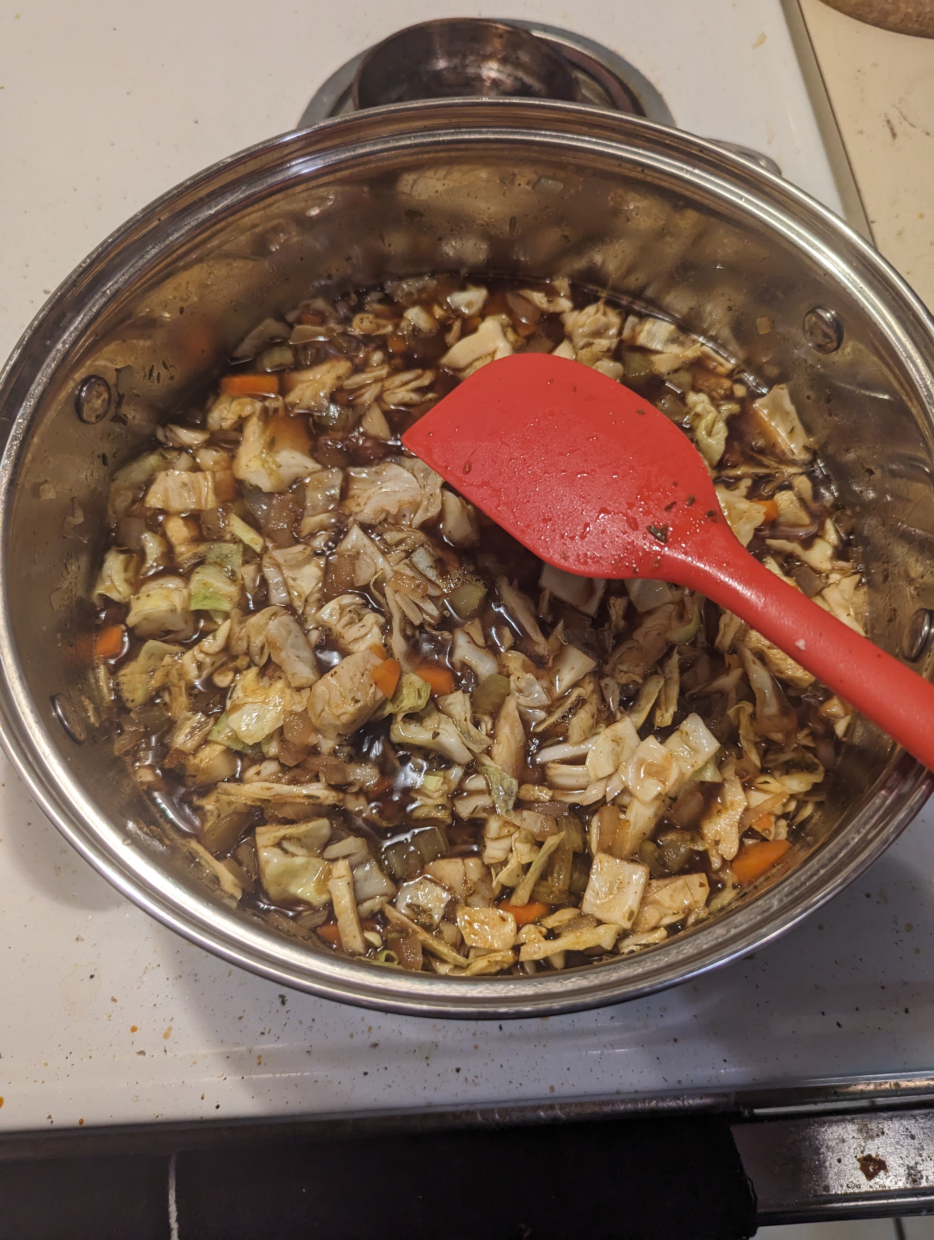 Mixing the cabbage into the stew